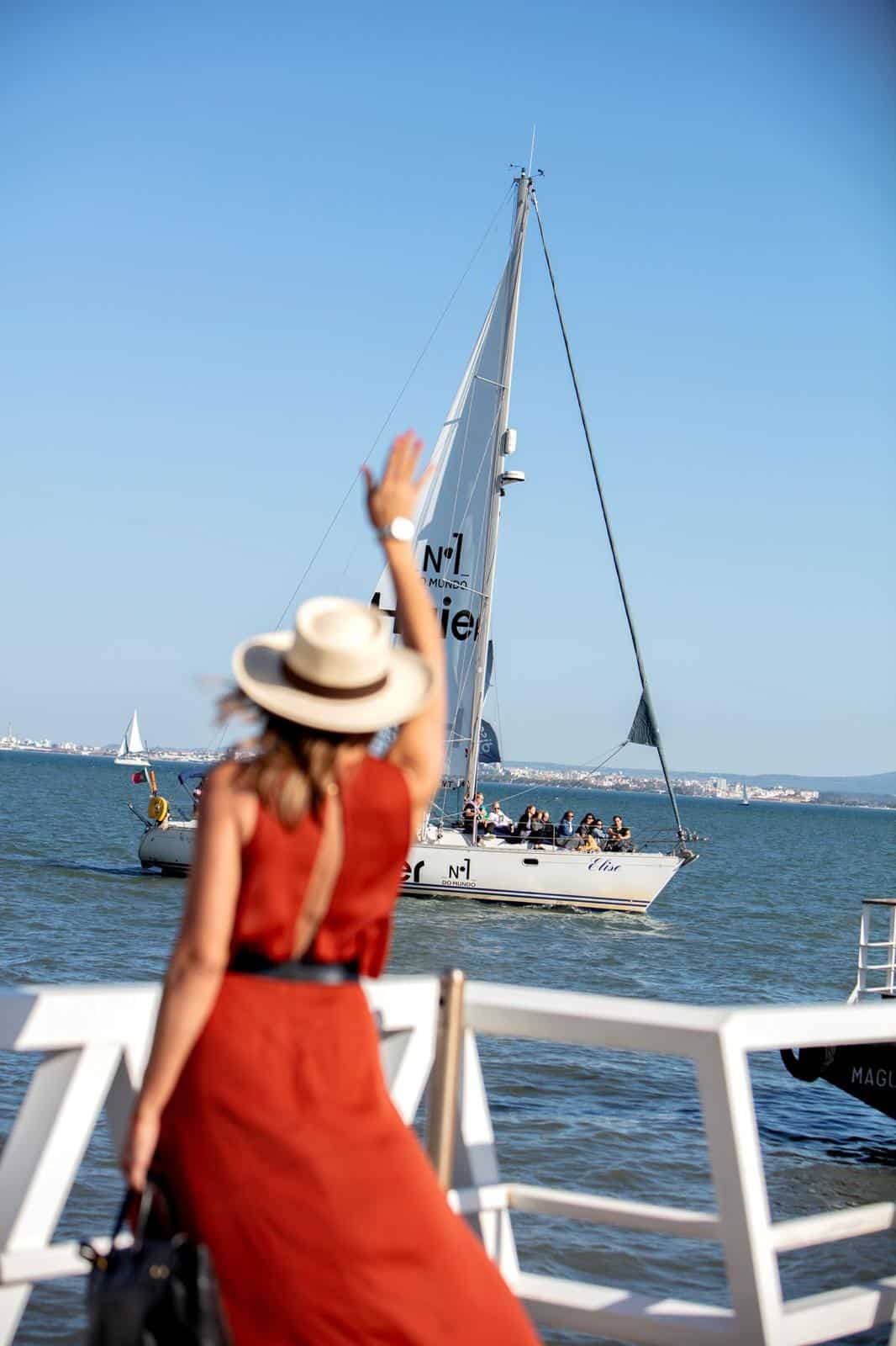 Elsa waves to the crew of a sailing boat