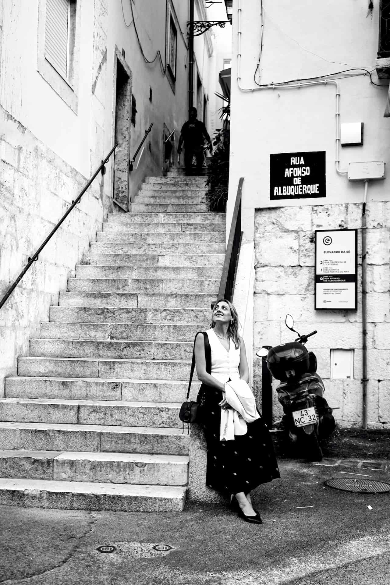 Elsa poses in front of a staircase at the entrance to the Alfama district