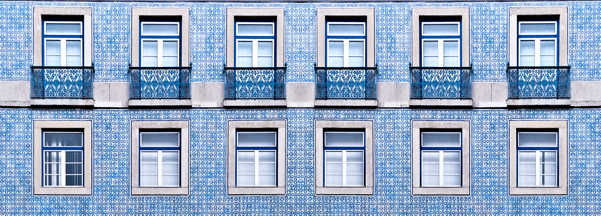 Lisbon windows with typical portuguese tiles on the wall